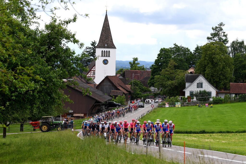 LACHEN SWITZERLAND JUNE 07 Matteo Badilatti of Switzerland Alexys Brunel of France Stefan Kng of Switzerland yellow leader jersey Fabian Lienhard of Switzerland Tobias Ludvigsson of Sweden Jake Stewart of United Kingdom Benjamin Thomas of France and Team Groupama FDJ Thomas Scully of New Zealand and Team EF Education Nippo Orange Mountain Jersey Stefan Bissegger of Switzerland and Team EF Education Nippo white best young jersey leads The peloton passing through Mrstetten Village landscape during the 84th Tour de Suisse 2021 Stage 2 a 178km stage from Neuhausen am Rheinfall to Lachen Landscape UCIworldtour tds tourdesuisse on June 07 2021 in Lachen Switzerland Photo by Tim de WaeleGetty Images
