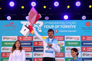 KUSADASI TURKEY APRIL 10 Vitaliy Buts of Ukraine and Sakarya Bb Pro Team celebrates at podium as white sprint points leader jersey winner during the 57th Presidential Cycling Tour Of Turkey 2021 Stage 1 a 202km stage from Bodrum to Kuadas TUR2022 on April 10 2022 in Kusadasi Turkey Photo by Dario BelingheriGetty Images