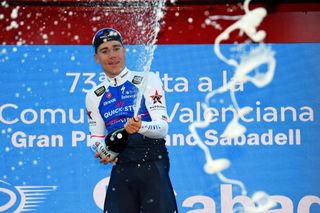 TORRENT SPAIN FEBRUARY 03 Fabio Jakobsen of Netherlands and Team QuickStep Alpha Vinyl celebrates at podium with champagne as stage winner during the 73rd Volta A La Comunitat Valenciana 2022 Stage 2 a 1715km stage from Btera to Torrent VCV2022 on February 03 2022 in Torrent Spain Photo by Dario BelingheriGetty Images