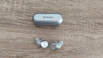 Technics EAH-AZ60 review: true wireless earbuds on a desk with a plant and a book