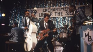Marty McFly (Michael J Fox) playing guitar on stage in Back to the Future