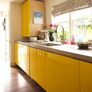 kitchen with yellow cabinet and wooden flooring