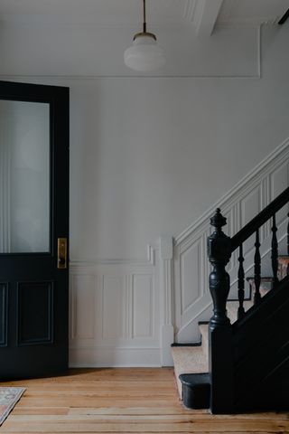An entryway with distinct crown molding and dado rails