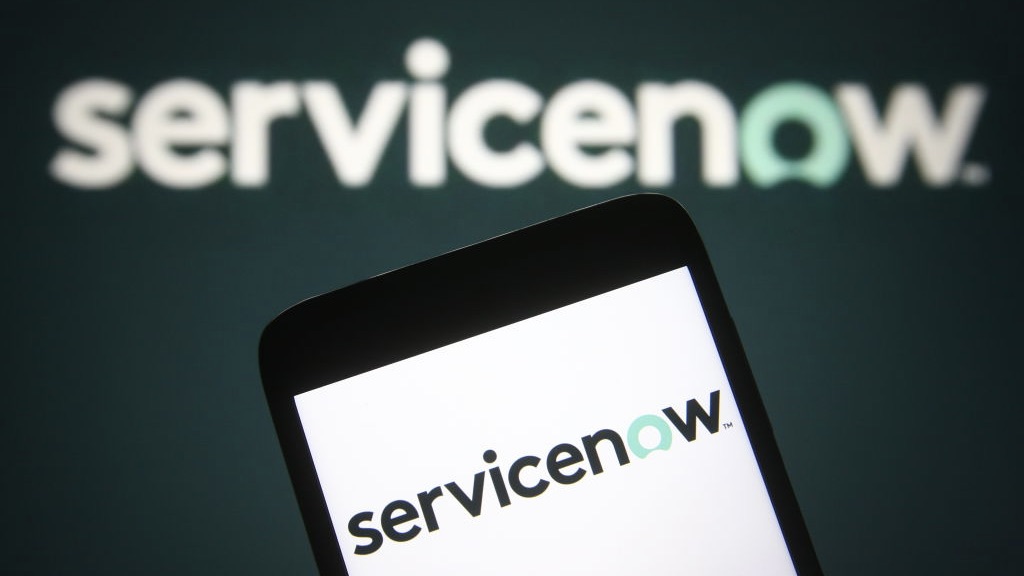 ServiceNow logo on mobile phone in front of background with ServiceNow logo