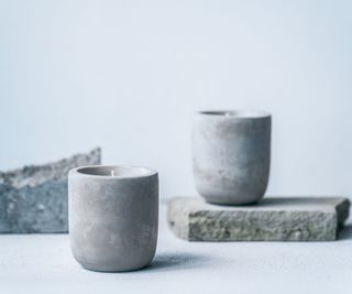 two candles on cement blocks