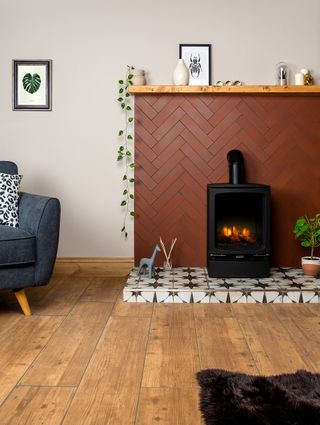 living room with black stove on black and white patterned hearth with salmon herringbone tiles behind