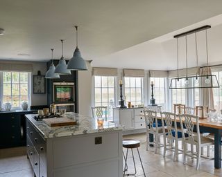 Kitchen remodel ideas shown through a picture of a new kitchen extension with traditional windows and statement lighting