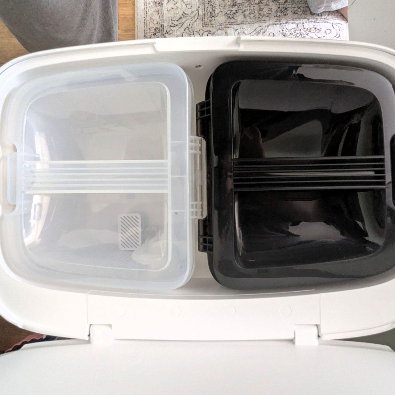 Close up of the white and black clean and dirty water tanks of the MOVA P50 Pro Ultra Robot Vacuum