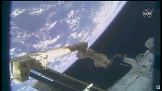 NASA astronaut Victor Glover rides on Canadarm2 to complete work during a spacewalk on Feb. 1, 2021.