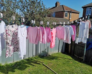 Clothes hung on hangers on washing line to dry without creasing