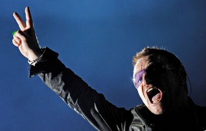 Bono performing at a U2 concert.