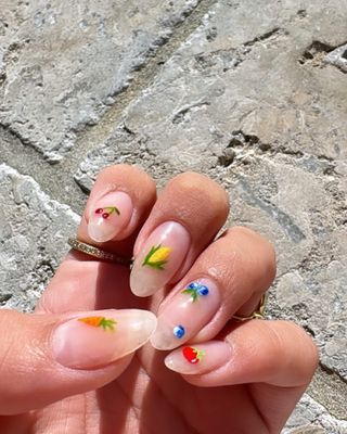 An image from @nailsbyzola of spring nail designs.