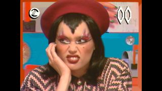 Blippo+ character Poly Pixel pulls a funny face with glancing away from the camera