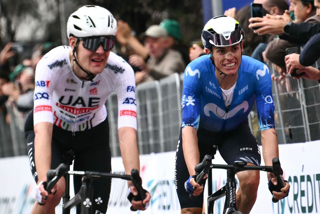 UAE Team Emirates team's French rider Pavel Sivakov (L) and Movistar Team's Spanish rider Enric Mas (R) cycle to the finish line of the 118th edition of the Giro di Lombardia (Tour of Lombardy), a 252km cycling race from Bergamo to Como on October 12, 2024. (Photo by Marco BERTORELLO / AFP)
