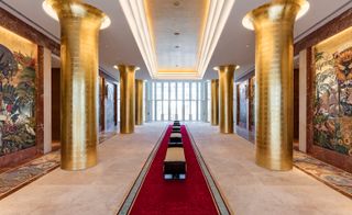 Hallway with thick golden painted columns