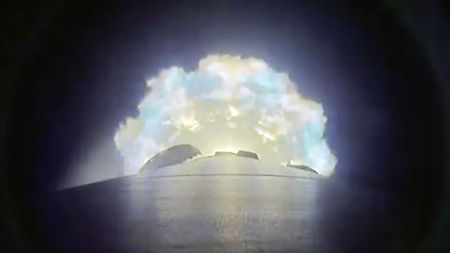 a camera mounted on the side of a rocket captures the plume from the booster's nine engines as they near cutoff and separation.