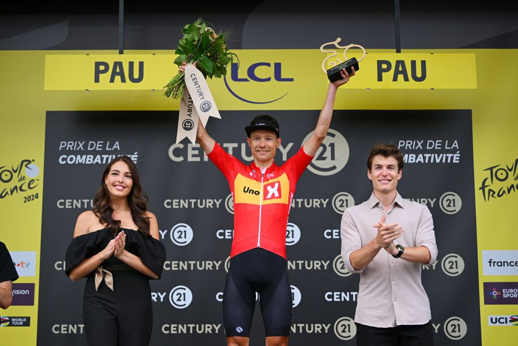 PAU FRANCE JULY 12 Magnus Cort of Denmark and Team UnoX Mobility celebrates at podium as most combative rider prize winner during the 111th Tour de France 2024 Stage 13 a 1653km stage from Agen to Pau UCIWT on July 12 2024 in Pau France Photo by Dario BelingheriGetty Images