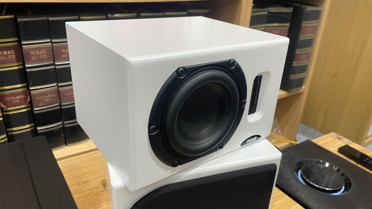 Neat Iota II speakers in white finish placed on wooden shelf