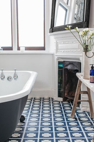 classic bathroom with roll top, blue patterned floor tiles