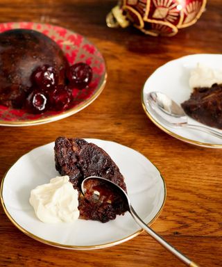 Christmas pudding served on plates on dining table