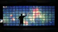 The center of the Milky Way galaxy imaged by NASA's Spitzer Space Telescope is displayed on a quarter-of-a-billion-pixel, high-definition 23-foot-wide (7-meter) LCD science visualization screen at NASA's Ames Research Center in Moffett Field, Calif.