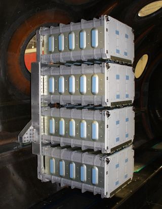 Four shuttle mid-deck lockers attached to an experiment rack inside SpaceShipTwo.