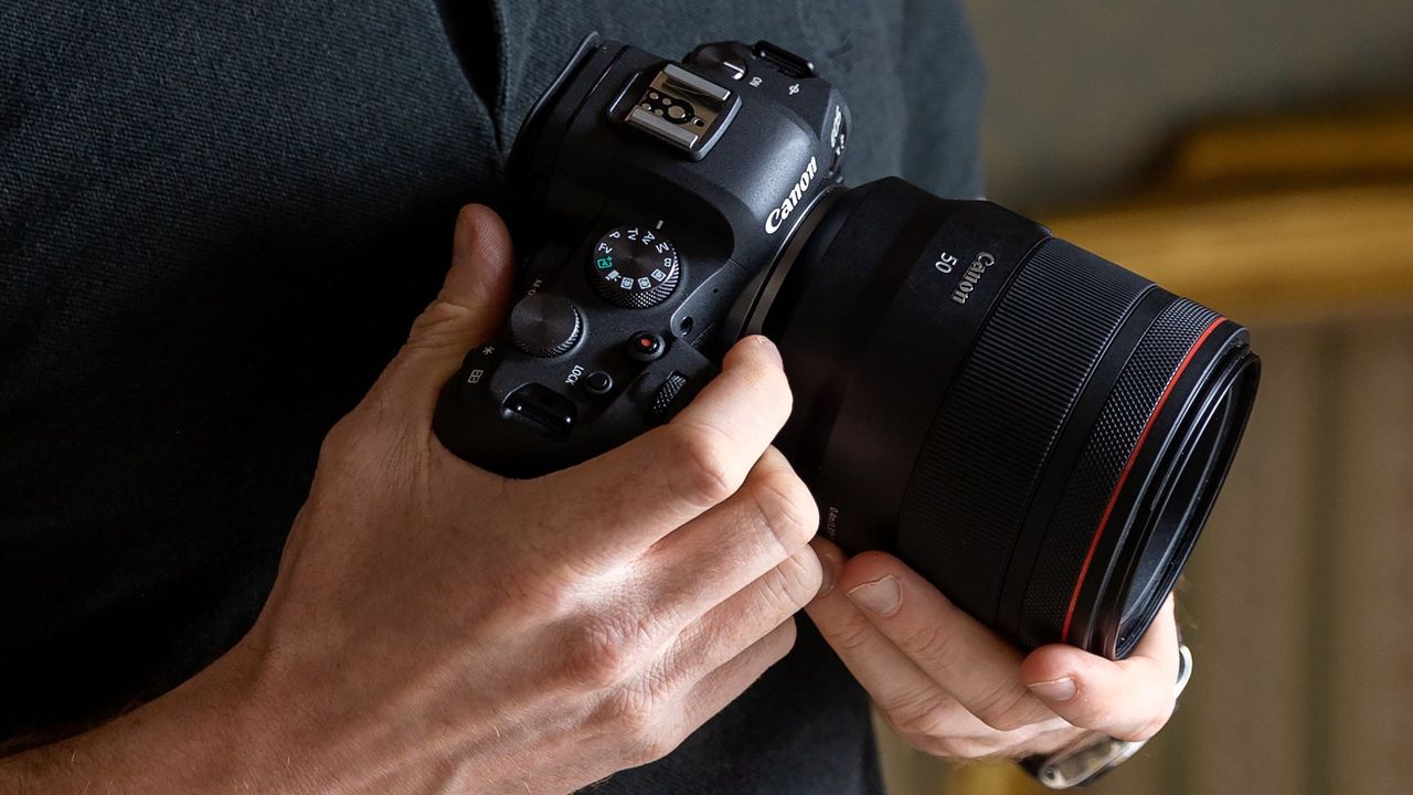 Canon EOS R6 in someone&#039;s hand with a lens attached