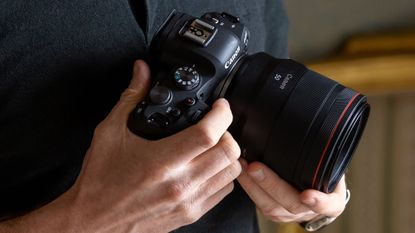 Canon EOS R6 in someone's hand with a lens attached