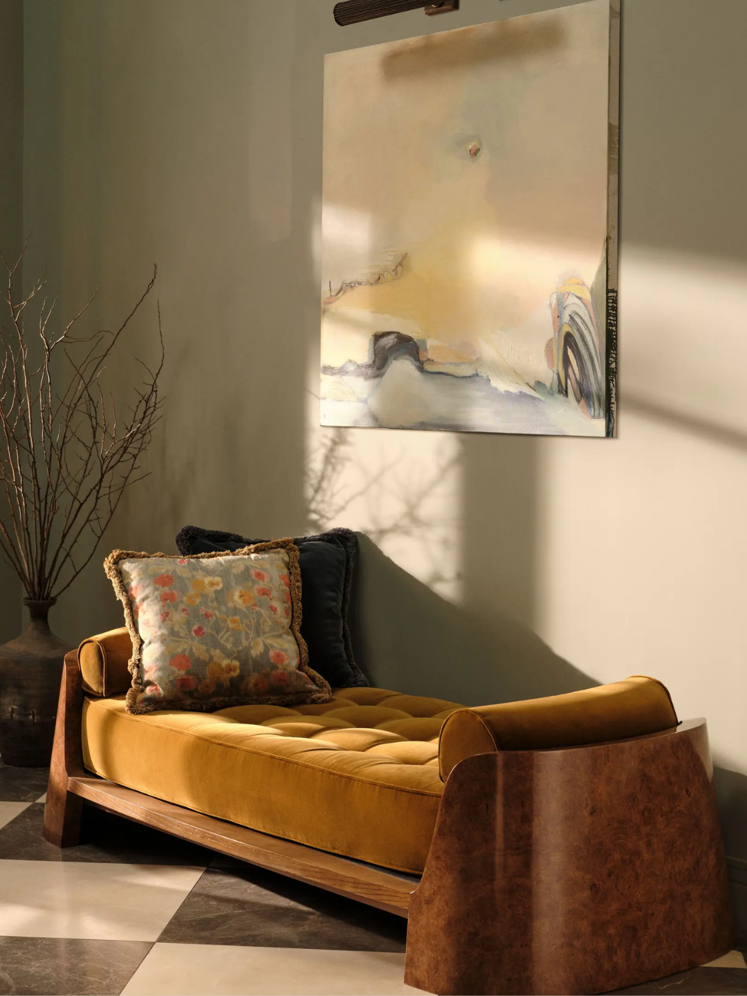A mustard velvet and oak burl daybed with a patterned tufted hem cushion from Soho Home
