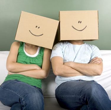 guy and girl with cardboard boxes over their heads with painted smiley faces