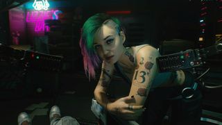 Judy Alvarez from Cyberpunk 2077 leaning on a table