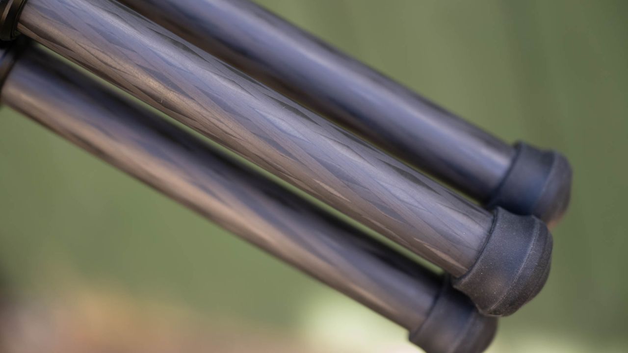 ZWO Seestar S50 Pro on a tripod against a green shed