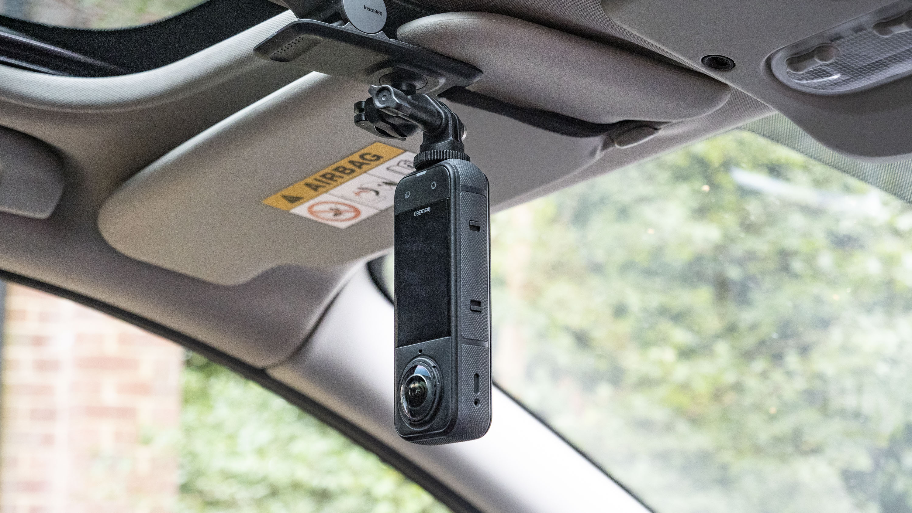 Insta360 X5 mounted to the Flexi Clip, attached to a car&#039;s sun shield