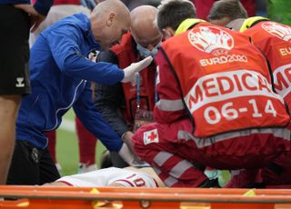 Christian Eriksen receives medical treatment during Denmark's opening Euro 2020 game against Finalnd at the Parken stadium in Copenhagen