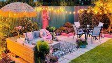 A pink outdoor patio space with string lights