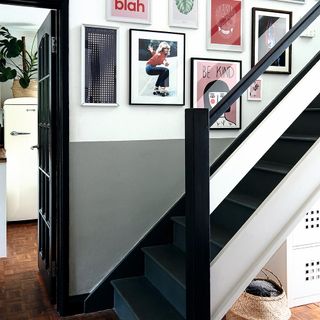 Hallway and stairs with various pictures on the wall