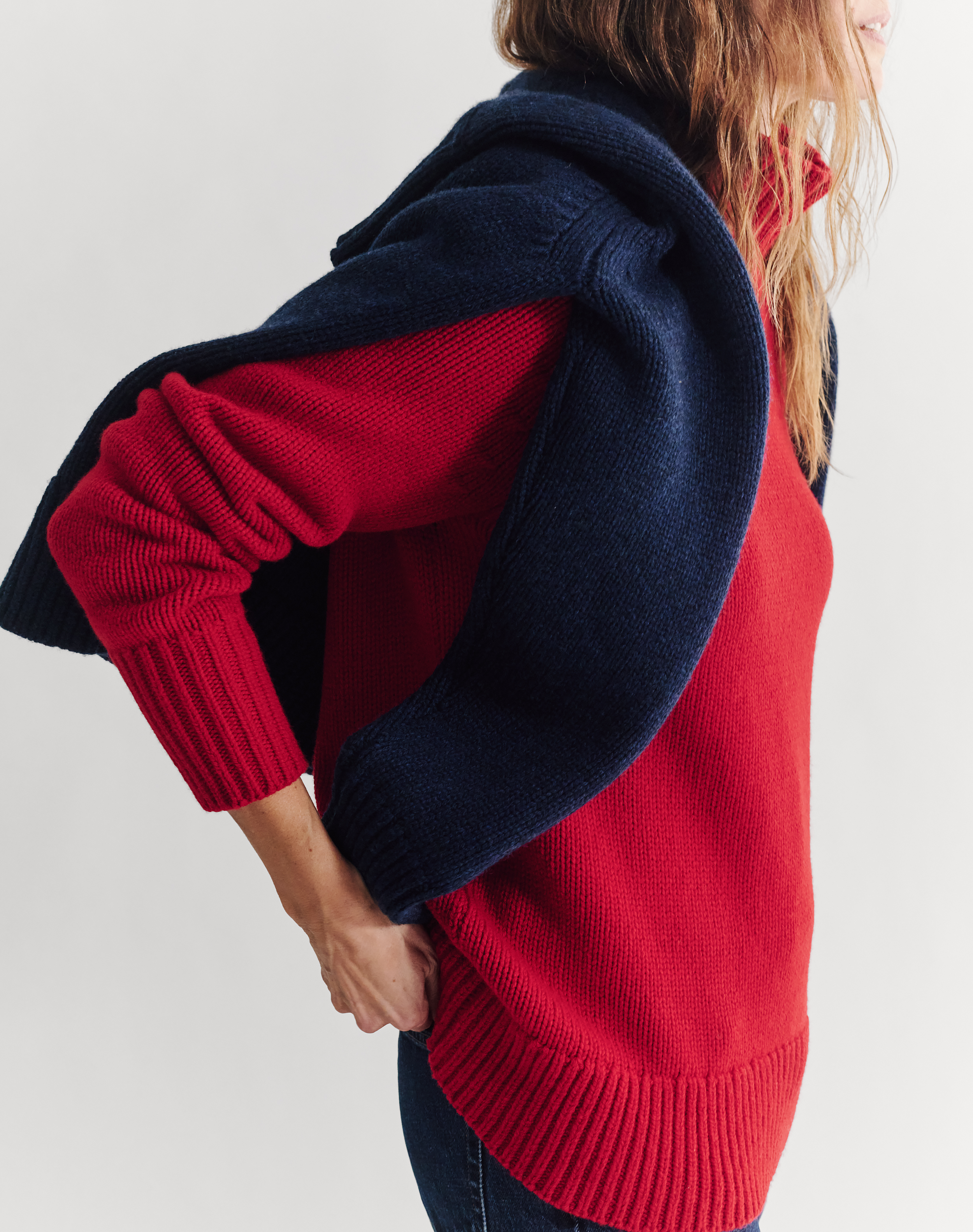 a model wearing a red jumper and blue jumper by navygrey