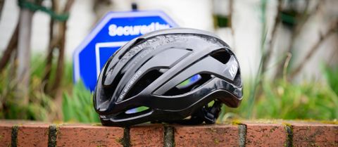 Kask elemento in front of a security sign