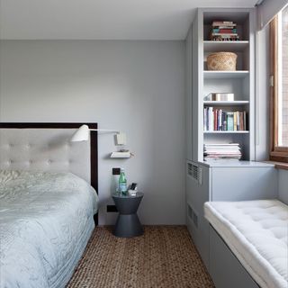 pale grey bedroom with storage and window seat