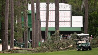Fallen trees in front of a scoreboard at Augusta National for the 2023 Masters