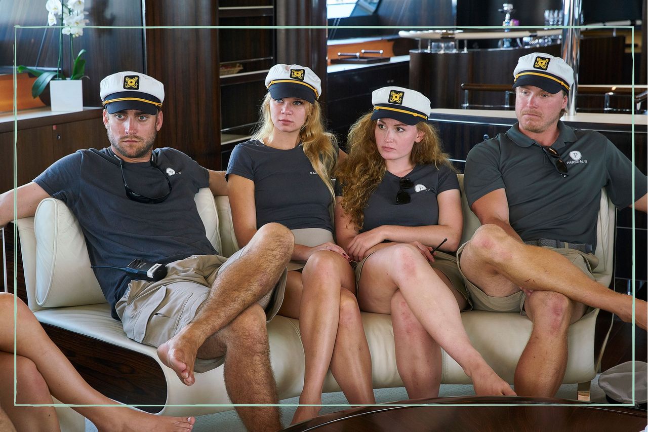 The cast of Below Deck Sailing Yacht sat on a sofa