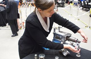 NASA's Jill McGuire swaps attachments that can fuel and repair satellites.