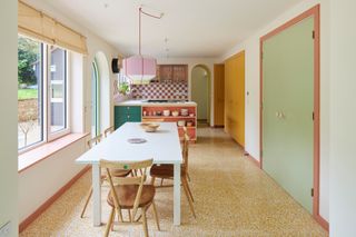 a kitchen diner with bold paint colors
