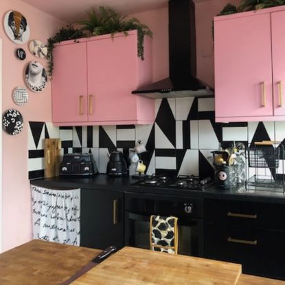 kitchen with pink cabinets and monochrome tiles