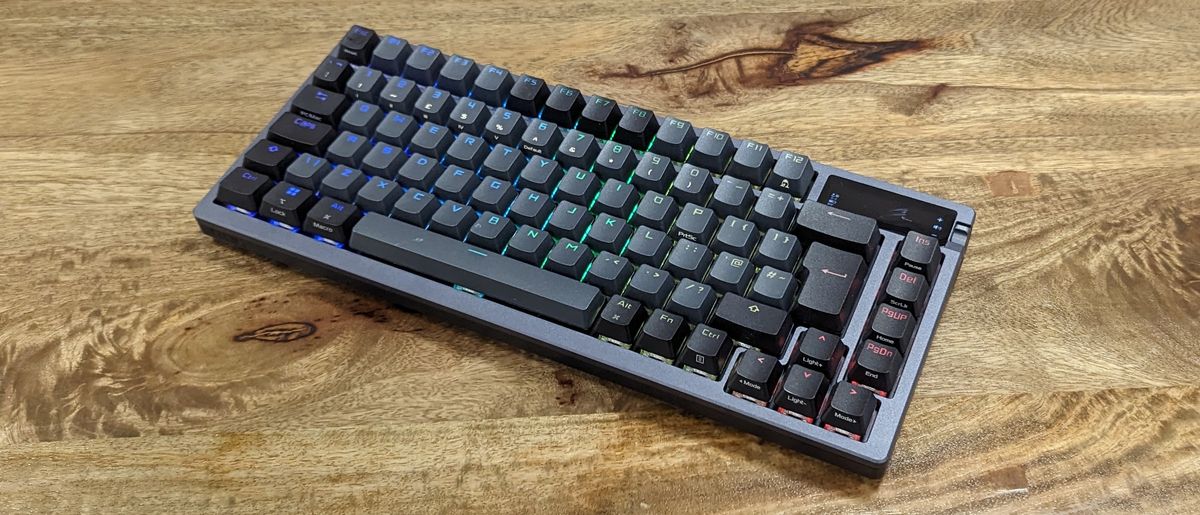 Asus ROG Azoth wireless gaming keyboard with RGB lighting on a wooden desk