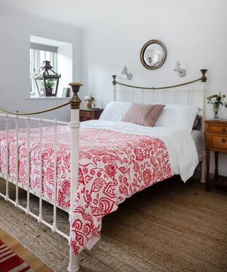 White and red country bedroom in Devon barn
