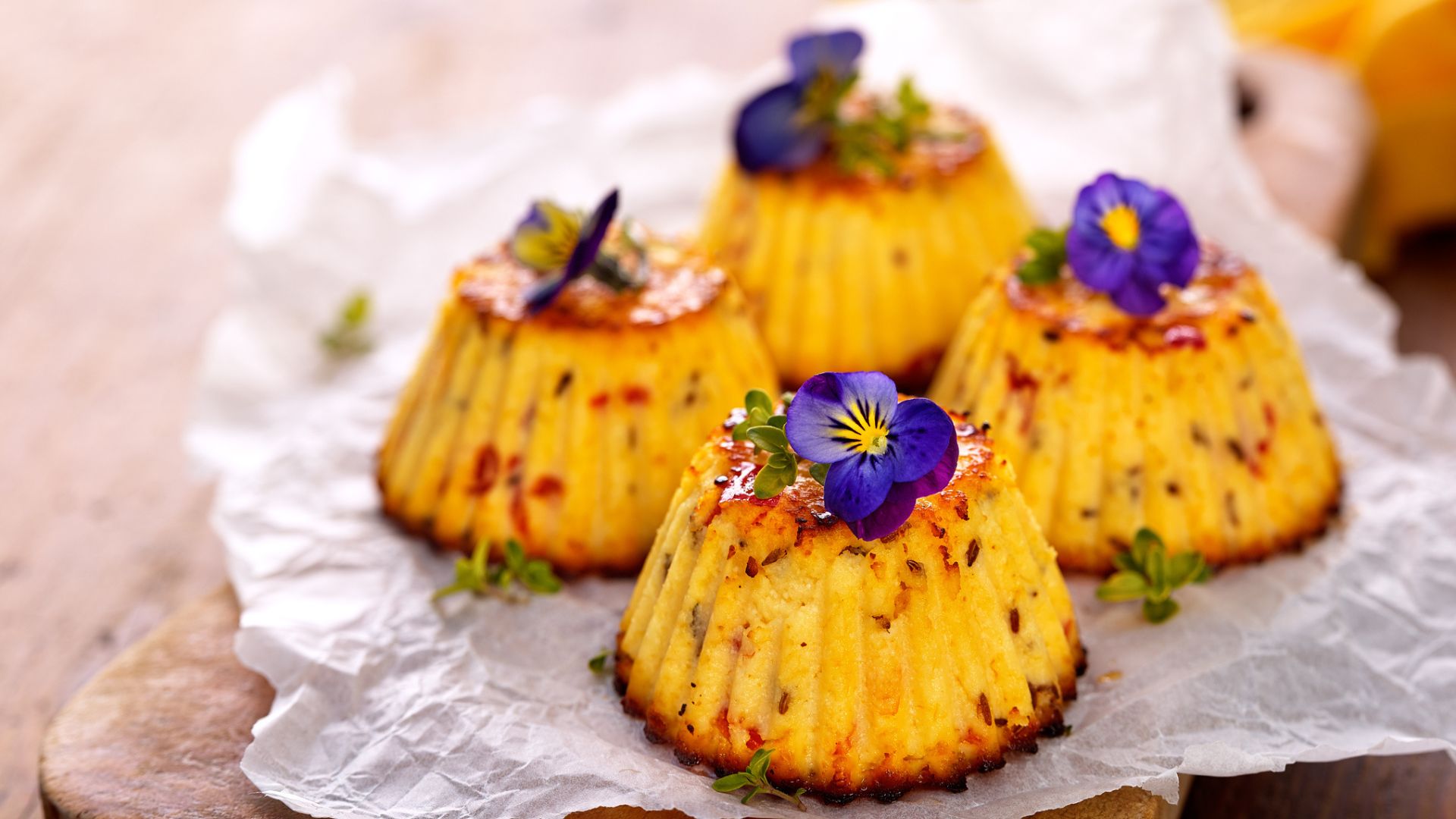 A plate of savoury scones decorated with edible flowers