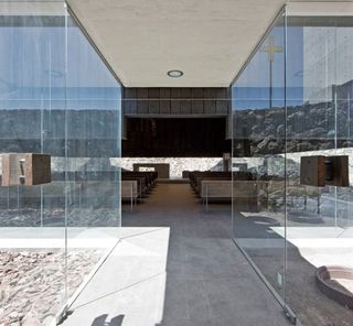 Seating area through glass walled corridor