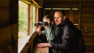 Man and son with binoculars bird watching