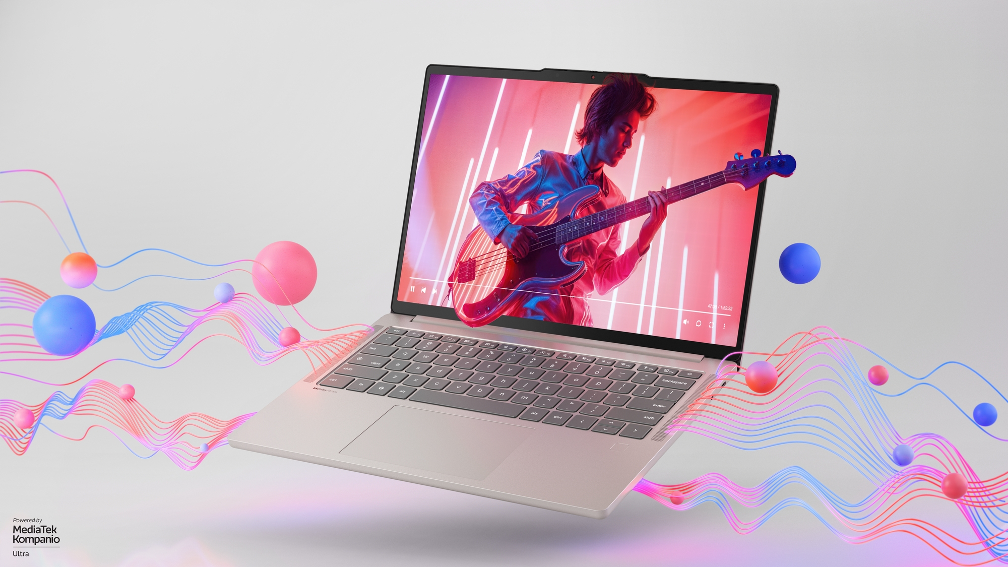 A Lenovo Chromebook Plus 14 laptop displaying a vibrant image of a musician playing an electric guitar. Colorful abstract 3D waves and spheres flow from the screen.